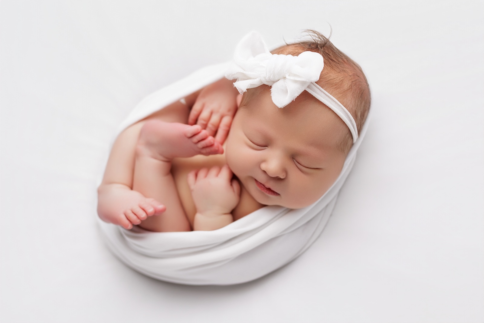 Swaddled newborn baby photographed at Level 11 Photography studio in Ramsgate Kent